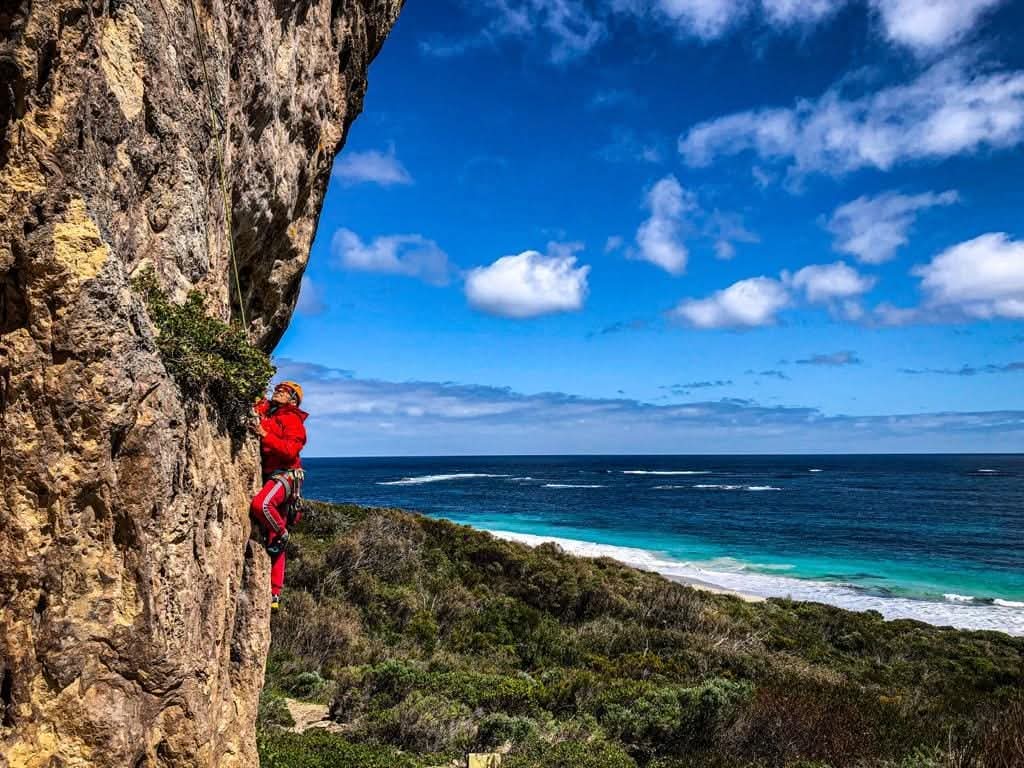 Manu rock climbing on a sea cliff in Western Australia